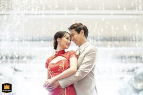 At the Four Seasons Hotel Bangkok, a newlywed couple shares an intimate portrait, posing amid the hotel's luxurious and modern architectural elements.